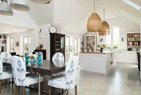 Modern country kitchen diner with fabric covered dining chairs 