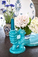 Candlestick and flower arrangements in ceramic pots 