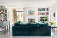 Modern living room with teal velvet sofa 