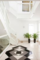 Patterned floor in contemporary minimal hallway 