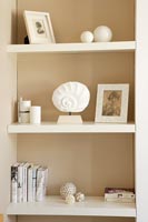 White shelves with pictures, books and ornaments 