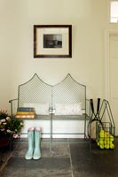 Metal bench seat in country hallway 