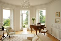 Baby grand piano in country living room 