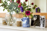 Flowers in vases on mantelpiece 
