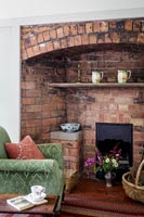 Fireplace in cosy living room in Arts and Cratfs country cottage