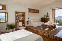 Bedroom suite with living area and views of Tuscan countryside 