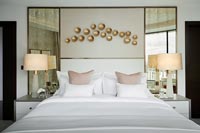 Modern bedroom with gold decorative feature wall 