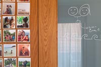 Drawing on glass door and display of family photographs  