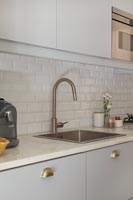Modern kitchen with brick style tiling 