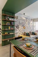 Green wooden frame with built in shelves, dining table and view to living room