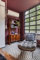 Chaise lounge and retro wooden cabinet in industrial living room 
