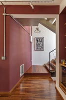 Hallway and stairs with dark red painted walls 