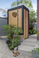 Small wooden structure in contemporary garden 
