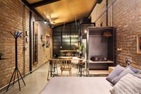 Modern industrial bedroom in open plan apartment