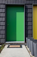 Bright green and neighbouring yellow front doors 