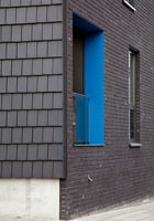 Black building with brightly coloured window surround 