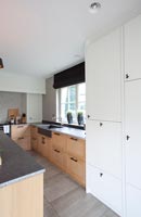 Contemporary kitchen with large white cabinets 