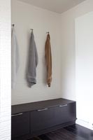 Towels and bench seat in modern bathroom 