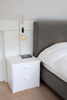 Modern bedroom with quirky bedside lamp 