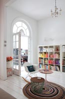 Modern living room with arched window above French doors 