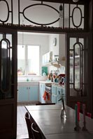 View through ornate glazed internal door to retro kitchen 
