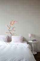 Fairy lights above bed in modern bedroom 