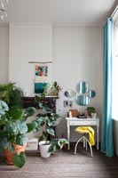 Houseplants in bedroom with classic dressing table 