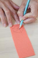 Woman drawing shape onto paper 