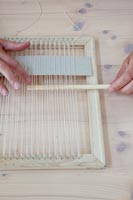 Crafting accessories on table - woman threading picture frame 