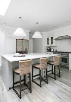 Modern grey and white kitchen with rattan bar stools 