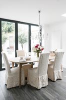 Fabric covered chairs around modern dining table 