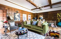 Eclectic living room with classic wooden paneling and exposed beams