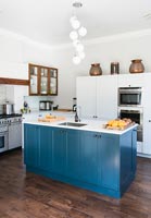 Blue painted island in modern kitchen 