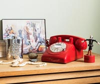 Red retro telephone on table 
