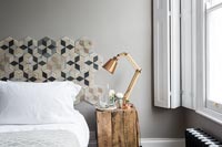 Modern bedroom with patterned headboard 