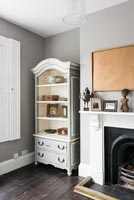 Wooden cabinet next to fireplace 