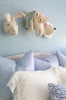 Wall mounted decorative toy animal heads in childs bedroom 