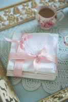 White serviettes tied with pink ribbon 