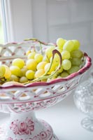Pink and white latticed fruit bowl with grapes 