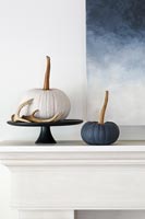 Modern country autumnal display with pumpkins and antlers 