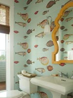 Colourful fish patterned wallpaper in bathroom 