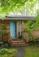 Exterior of wooden cabin in woodland