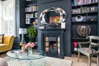 Black painted feature wall and fireplace in modern living room 