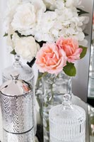 Flower arrangement on modern mirrored dressing table 