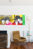 Colourful artwork and vintage armchair 