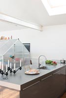 Modern kitchen worktop with sink and greenhouse structure 