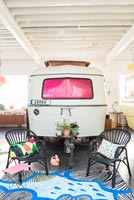 Vintage caravan and seating area in industrial childrens room 