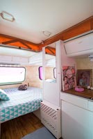 Interior of vintage caravan used as childrens bedroom 