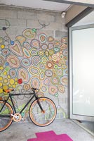 Colourful mural on hallway wall with bicycle 