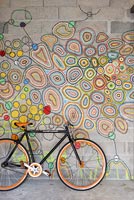 Bicycle against colour painted wall